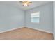 A bright, empty bedroom with neutral walls and carpet at 10478 Coquina Ct, Placida, FL 33946