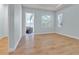 Bright bedroom featuring wood flooring, a large window, and a view of the outdoor patio at 10478 Coquina Ct, Placida, FL 33946