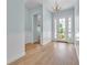 Elegant entryway with light blue walls, white wainscoting, wood-look floors, and a view into the living area at 10478 Coquina Ct, Placida, FL 33946