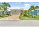 Attractive single-story home with a well-kept lawn and brick driveway in a residential neighborhood at 10478 Coquina Ct, Placida, FL 33946