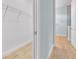 Hallway view leading to bathroom and closet featuring wood flooring at 10478 Coquina Ct, Placida, FL 33946