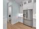 Stainless steel refrigerator near a hallway and pantry in this modern kitchen at 10478 Coquina Ct, Placida, FL 33946