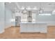Stylish kitchen with white cabinets, stainless steel appliances, and a large island for food preparation at 10478 Coquina Ct, Placida, FL 33946