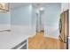 Kitchen leading to the hallway and bathroom, stainless steel refrigerator, and beautiful wood flooring at 10478 Coquina Ct, Placida, FL 33946