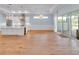 Open concept kitchen with stainless appliances, an island with wine cooler, and a sliding door to the patio at 10478 Coquina Ct, Placida, FL 33946