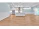 Modern kitchen with stainless steel appliances, white cabinetry, and an island with pendant lighting at 10478 Coquina Ct, Placida, FL 33946