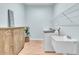 Well-lit laundry room with modern washer and dryer, storage cabinet, sink, and wood-look flooring at 10478 Coquina Ct, Placida, FL 33946