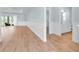 Spacious living area with wood-look floors, wainscoting, and sliding glass doors to the outdoor area at 10478 Coquina Ct, Placida, FL 33946