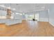 Open-concept living area with wood-look flooring, pendant lights, and access to the outdoor patio at 10478 Coquina Ct, Placida, FL 33946