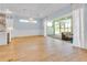Spacious living room featuring wood floors, modern chandelier, and sliding doors to the lanai at 10478 Coquina Ct, Placida, FL 33946