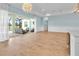 Open living room with hardwood floors and views to outdoor patio at 10478 Coquina Ct, Placida, FL 33946