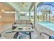 Relaxing outdoor living space featuring a sofa and view of the pool and backyard at 10478 Coquina Ct, Placida, FL 33946