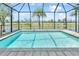 Inviting screened pool with serene pond views and tropical landscaping at 10478 Coquina Ct, Placida, FL 33946