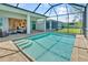 Sparkling pool with brick pavers and a screened enclosure, perfect for enjoying the outdoors at 10478 Coquina Ct, Placida, FL 33946