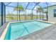 Beautiful screened pool surrounded by brick pavers, overlooking a serene pond and lush palms at 10478 Coquina Ct, Placida, FL 33946