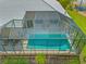 Aerial view of home's screened-in pool area, with patio and views of tropical landscaping at 1323 Mineo Dr, Punta Gorda, FL 33950