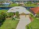 Aerial view of home showcasing tile roof, landscaping, and long driveway at 1323 Mineo Dr, Punta Gorda, FL 33950