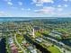 Aerial view of waterfront homes nestled along a canal community with a bay in the background at 1323 Mineo Dr, Punta Gorda, FL 33950