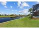 Waterfront property with canal view, lush lawn, and tropical landscaping at 1323 Mineo Dr, Punta Gorda, FL 33950