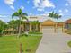 Beautiful home featuring a tile roof, mature landscaping, and a spacious driveway at 1323 Mineo Dr, Punta Gorda, FL 33950