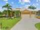 Charming home featuring a tile roof, well-manicured lawn, and a two-car garage at 1323 Mineo Dr, Punta Gorda, FL 33950