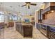 Bright kitchen open to dining and living areas featuring granite island, dark wood cabinets, and modern appliances at 1323 Mineo Dr, Punta Gorda, FL 33950