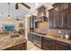 Modern kitchen showcasing dark wood cabinets, granite countertops, and stainless steel appliances at 1323 Mineo Dr, Punta Gorda, FL 33950