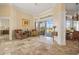 Elegant living room with travertine flooring, comfortable seating, and views of the pool area at 1323 Mineo Dr, Punta Gorda, FL 33950