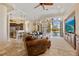 Open-concept living room with views of the backyard pool, linking kitchen, dining, and living spaces at 1323 Mineo Dr, Punta Gorda, FL 33950