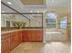 Bathroom featuring double vanity, granite counters, and soaking tub with large window at 1323 Mineo Dr, Punta Gorda, FL 33950