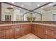 Bathroom featuring double vanity, granite counters, and travertine floors at 1323 Mineo Dr, Punta Gorda, FL 33950