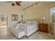 Comfortable main bedroom featuring travertine flooring and a sitting area at 1323 Mineo Dr, Punta Gorda, FL 33950