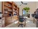 Well-appointed office with built-in bookshelves, travertine flooring, and ample natural light at 1323 Mineo Dr, Punta Gorda, FL 33950
