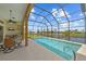 Beautiful screened-in pool area with seating, dining, and outdoor cooking areas with lovely views at 1323 Mineo Dr, Punta Gorda, FL 33950