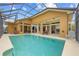 Spacious screened-in pool with outdoor seating and access to the home's interior at 1323 Mineo Dr, Punta Gorda, FL 33950