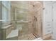 Luxurious walk-in shower with a bench and glass door at 1323 Mineo Dr, Punta Gorda, FL 33950