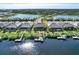 Aerial view of waterfront homes with private docks and lush landscaping in a picturesque community at 14436 Ponce De Leon Trl, Port Charlotte, FL 33981