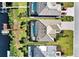 Aerial view of tile-roofed waterfront homes with docks, screen enclosed pools, and well-maintained lawns at 14436 Ponce De Leon Trl, Port Charlotte, FL 33981