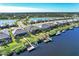 Picturesque waterfront community with private docks and lush greenery, showcasing luxury homes at 14436 Ponce De Leon Trl, Port Charlotte, FL 33981