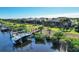 Aerial view of waterfront homes featuring private docks, lush landscaping, screened lanais, and waterway access in a coastal community at 14436 Ponce De Leon Trl, Port Charlotte, FL 33981