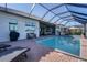 This backyard features a pool, screened-in patio and is great for entertaining at 14436 Ponce De Leon Trl, Port Charlotte, FL 33981