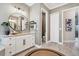 Bright bathroom with granite counters, a round mirror, and decorative accents at 14436 Ponce De Leon Trl, Port Charlotte, FL 33981