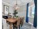 Dining room with pendant lighting, dining table, and floor-to-ceiling blue drapes at 14436 Ponce De Leon Trl, Port Charlotte, FL 33981