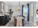 Cozy dining room with modern lighting fixture, wood table, and a view of the outside at 14436 Ponce De Leon Trl, Port Charlotte, FL 33981