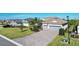 Stunning curb appeal, featuring tropical landscaping, a two-car garage and a brick paver driveway at 14436 Ponce De Leon Trl, Port Charlotte, FL 33981