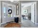 Inviting foyer with tile floors, a decorative rug, and a glimpse of the home office at 14436 Ponce De Leon Trl, Port Charlotte, FL 33981