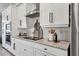 Modern kitchen showcasing white cabinets, granite countertops, and stainless steel appliances at 14436 Ponce De Leon Trl, Port Charlotte, FL 33981