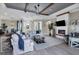 This living room offers wood look tile flooring, cozy fireplace, and ample space for entertaining at 14436 Ponce De Leon Trl, Port Charlotte, FL 33981