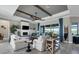 Inviting living room with wood beams, modern fireplace, tile flooring, and elegant decor at 14436 Ponce De Leon Trl, Port Charlotte, FL 33981