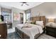 A well-lit main bedroom with a large bed, desk, nightstands, and decorative artwork at 14436 Ponce De Leon Trl, Port Charlotte, FL 33981